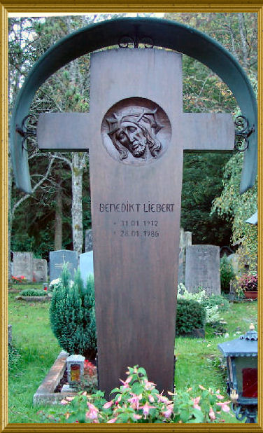 Wooden cross with the head of Christ in relief